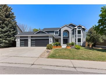 Charming two-story home with a three car garage, landscaped yard, and a modern exterior design at 9382 Lark Sparrow Dr, Highlands Ranch, CO 80126
