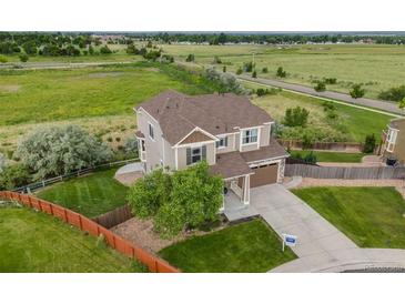 Beautiful two-story home with a well-manicured lawn and large backyard at 3620 Sandoval St, Brighton, CO 80601
