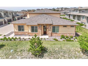 Charming single Gathering home showcasing stone accents, manicured lawn, and tasteful landscaping at 12258 Hazel Spruce Ct, Parker, CO 80134