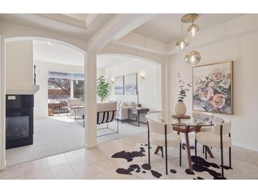 Bright living area featuring a fireplace, open floor plan, and access to an outdoor balcony at 1747 N Washington St # C306, Denver, CO 80203