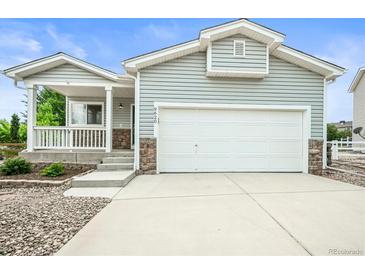 Charming home with attached two-car garage, covered porch and stone accents at 9620 Mallard Pond Way, Littleton, CO 80125