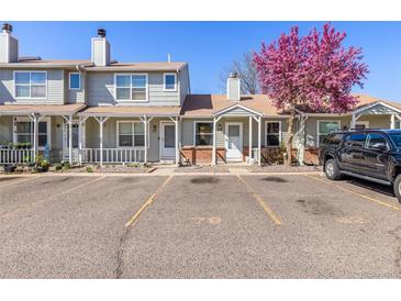 Well-maintained townhome with private parking, front porch, and blooming tree at 8260 Washington St # 78, Denver, CO 80229