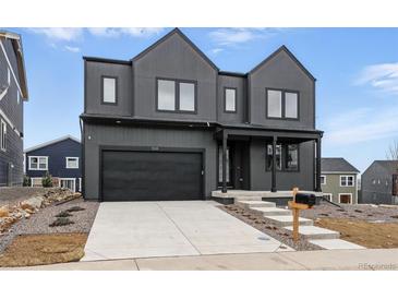 Modern two-story home featuring a two-car garage, covered porch, and contemporary design elements at 924 Sunflower St, Louisville, CO 80027