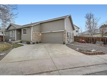 Charming home with a two car garage and a beautifully landscaped front yard at 8345 Moore St, Arvada, CO 80005