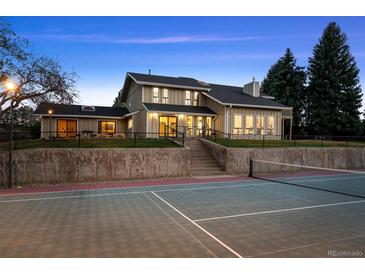 Exterior view of a charming home featuring a private tennis court, perfect for recreation and fitness at 6668 Walker Ct, Niwot, CO 80503