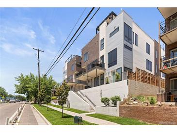 Modern townhome exterior featuring balconies, clean lines, and stylish landscaping at 2851 W 23Rd Ave # 1, Denver, CO 80211