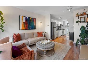 Bright living room features stylish furniture, large artwork, and an open floor plan at 1300 Garfield St # 9, Denver, CO 80206