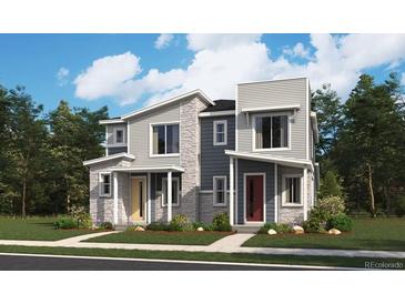 Modern two-story townhomes featuring stone accents and colorful front doors with well-maintained landscaping at 17095 E Alameda Pkwy, Aurora, CO 80017