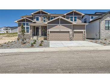 Beautiful two-story home featuring a two-car garage and stone accents, enhancing its curb appeal at 4748 Weitbrec Ln, Castle Rock, CO 80104