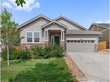 Charming single-story home boasts stone accents, a two-car garage, and a well-manicured lawn at 6484 S Harvest St, Aurora, CO 80016