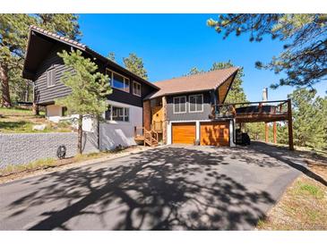 Inviting exterior showcasing a two-story home, a spacious driveway, and a two-car garage at 2976 Hiwan Dr, Evergreen, CO 80439