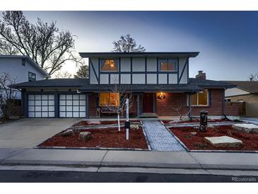 Charming two-story home with brick and siding exterior, a two-car garage, and a professionally landscaped front yard at 10321 W 101St Pl, Broomfield, CO 80021