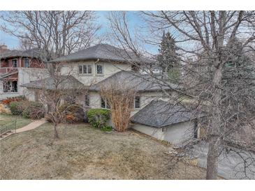 Charming home with a gray roof and neutral siding, complemented by mature trees and lush landscaping at 1590 S Milwaukee St, Denver, CO 80210