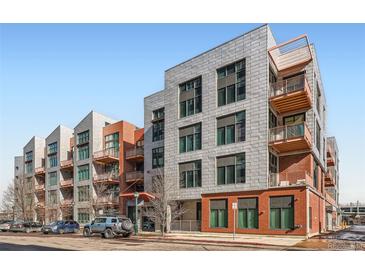 Modern condo building showcasing sleek design, balconies, and city views on a sunny day at 3100 Huron St # 3E, Denver, CO 80202