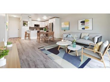 Open living room, kitchen combo with wood-look floors and modern furniture at 715 S Alton Way # 5A, Denver, CO 80247