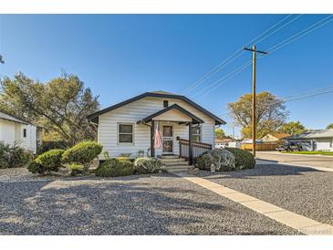 Charming single-story home with a well-maintained lawn and inviting front porch at 101 S 11 Ave, Brighton, CO 80601