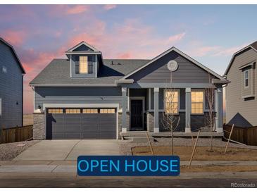 Charming single-Gathering home featuring a two-car garage and stylish architectural details at 9099 Pitkin St, Commerce City, CO 80022