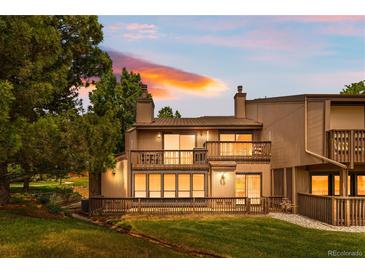 Charming condo with a spacious deck overlooking a well-manicured lawn at sunset at 7300 W Stetson Pl # 46, Littleton, CO 80123