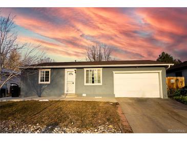 Charming single-story home with gray siding, a well-maintained lawn, and a two-car attached garage at 5344 Wheeling St, Denver, CO 80239