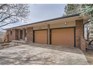 The exterior shows a brick home with a two-car garage, and a concrete driveway at 17306 W 17Th Pl, Golden, CO 80401