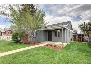 Charming gray bungalow with green lawn, sidewalk, and a mature tree enhancing its curb appeal at 3320 N Madison St, Denver, CO 80205