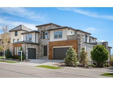 Beautiful, modern two-story home with stone accents, a two-car garage, and a well-manicured lawn at 2136 S Juniper St, Lakewood, CO 80228