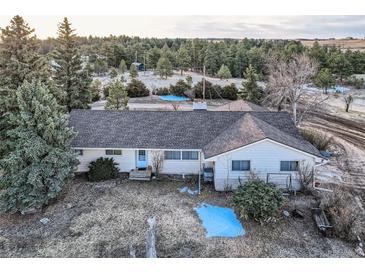 Charming ranch-style home featuring a well-maintained roof and mature trees on a large lot at 754 Highway 86 Hwy, Elizabeth, CO 80107