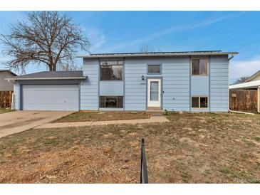Charming two-story home features a light blue exterior, attached garage, and well-lit entrance at 15640 E Eldorado Dr, Aurora, CO 80013