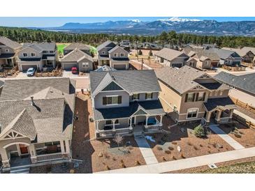 Stunning home with mountain views, gray siding, dark roof, and manicured landscaping in a vibrant neighborhood at 668 Sage Forest Ln, Monument, CO 80132