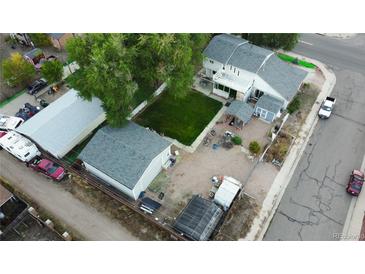 Spacious home featuring a large backyard, detached garage, and additional outdoor structures at 195 Briggs St, Erie, CO 80516