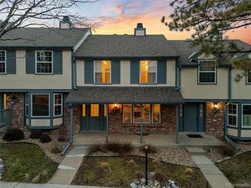 Charming townhouse with brick accents, inviting porch, and well-maintained landscaping at 7068 E Briarwood Dr, Centennial, CO 80112