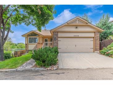 Charming single-Gathering home with a two-car garage, lush lawn, and well-maintained landscaping at 10478 W 82Nd Ave, Arvada, CO 80005