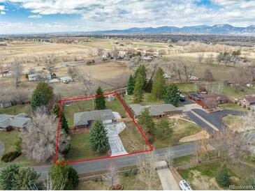 Sprawling property with mature trees, a fenced yard, and mountain views in a desirable location at 1723 Stonehenge Dr, Lafayette, CO 80026