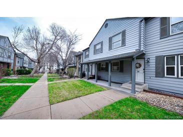 Charming townhouse with well-maintained front yard and welcoming covered porch at 677 Vrain St # 15, Denver, CO 80204
