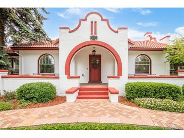 Charming front entrance with red brick accents, a red front door and manicured landscaping at 2715 W 37Th Ave, Denver, CO 80211
