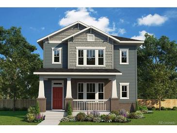Charming two-story home with a covered front porch and beautifully landscaped yard at 21034 E 63Rd Dr, Aurora, CO 80019