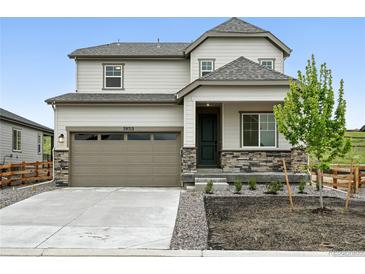Charming two-story home featuring stone accents, a two-car garage, and a well-maintained front yard at 39713 Penn Rd, Elizabeth, CO 80107