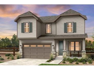 Charming two-story home featuring a two-car garage, stone accents, and a well-maintained front yard at 39713 Penn Rd, Elizabeth, CO 80107