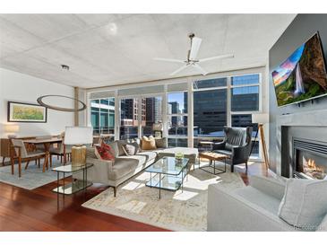 Bright living room featuring floor-to-ceiling windows with city views and modern decor at 1620 Little Raven St # 302, Denver, CO 80202