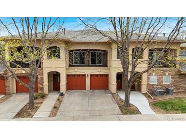 A charming townhome with a 2-car garage, balcony, and beautifully landscaped front yard provides great curb appeal at 1703 Whitehall Dr # 5I, Longmont, CO 80504