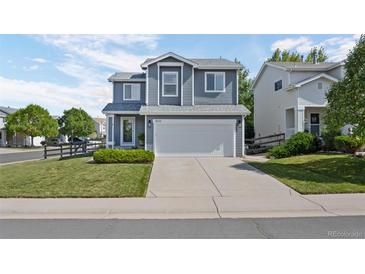 Charming two-story home featuring a manicured front yard, large garage and inviting curb appeal at 9603 Marmot Ridge Cir, Littleton, CO 80125