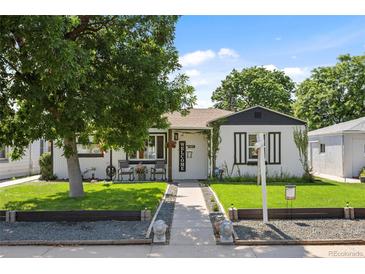 Charming home with a well-manicured front yard and welcoming entrance, featuring a mature shade tree at 4389 S Sherman St, Englewood, CO 80113