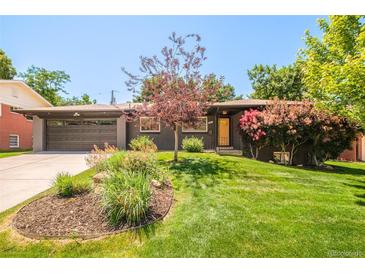 Charming single-story home featuring a landscaped front yard and an attached two-car garage at 621 S Harrison Ln, Denver, CO 80209