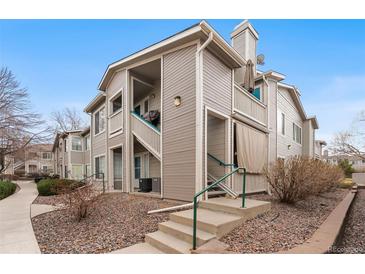 Charming multi-level condo featuring a private balcony and well-maintained landscaping at 3857 Mossy Rock Dr # 201, Highlands Ranch, CO 80126
