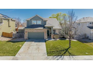 Charming two-story home with a well-maintained lawn and a two-car attached garage at 3788 Chavez St, Brighton, CO 80601