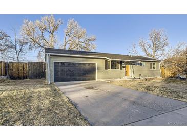 Charming single-story home with an attached garage and a large driveway at 1205 W 101St Ave, Northglenn, CO 80260