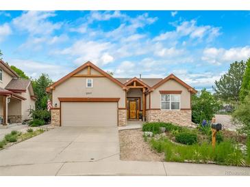 Charming single-Gathering home featuring a two-car garage, manicured landscaping and a lovely stone accent at 2807 S Nelson St, Lakewood, CO 80227