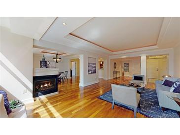 Spacious living room featuring a fireplace and gleaming hardwood floors, perfect for entertaining at 1891 Curtis St # 1613, Denver, CO 80202