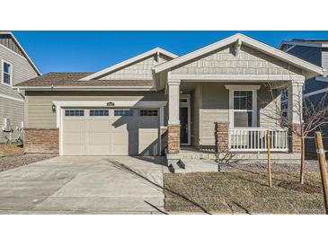 Modern craftsman style home with a two-car garage and front porch at 4847 Astor Pl, Brighton, CO 80601