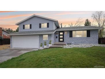 Charming two-story home with a well-maintained lawn and an attached two-car garage at 9435 Osceola St, Westminster, CO 80031
